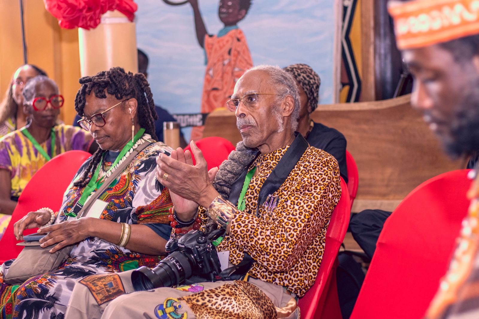 Sankɔfa Journey participant applauding during a gathering